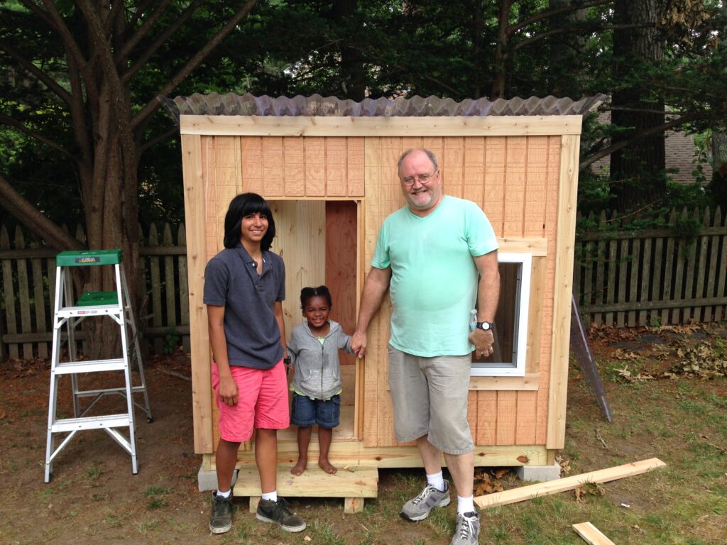 Craig Watson, the author's father, builds a playhouse for his granddaughter with the help of the author's youngest sister